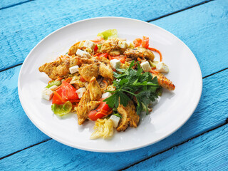 Chicken salad on blue wooden background