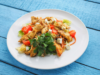 Chicken salad on blue wooden background