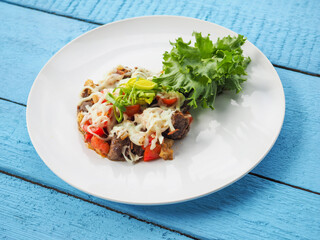 Meat salad on blue wooden background