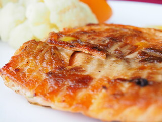 Baked salmon in foil on a red background