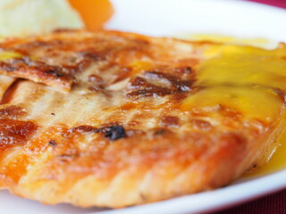 Baked salmon in foil on a red background