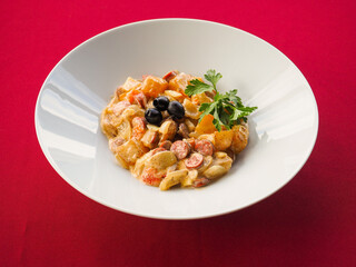 Sausage salad on red background