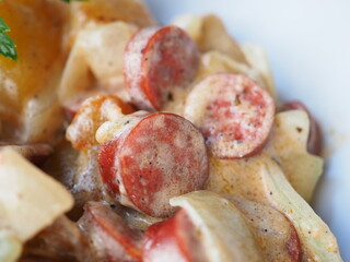 Sausage salad on red background