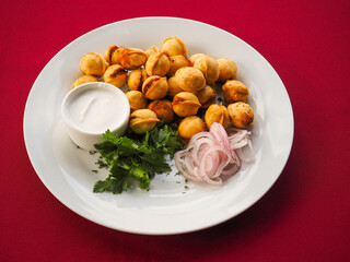 Fried dumplings with dill in a plate