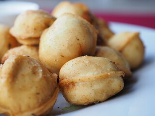 Fried dumplings with dill in a plate