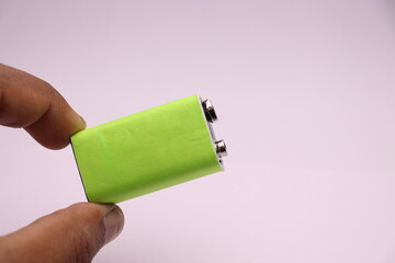 Alkaline battery or 9v battery with space for label held in hand