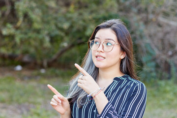 Young woman making directions or choices with nature background