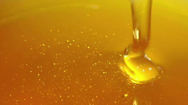 Pouring honey. Close-up of honey dripping.