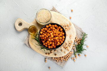 Vegan healthy snack, homemade roasted chickpeas in bowl on light gray background.