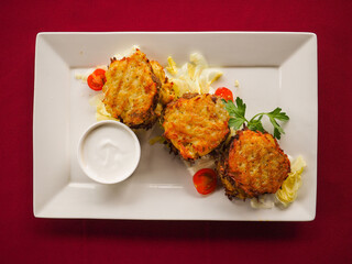 Beefsteak with tomato and herbs on a red background