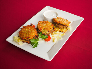 Beefsteak with tomato and herbs on a red background