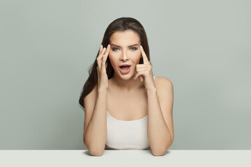 Face gymnastics. Healthy model woman touching her hands her face