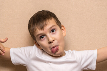 child indulges in front of the camera. portrait of a boy of six years old close-up.