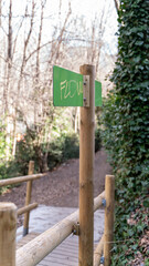 
graffiti says FLOW over the green park sign
