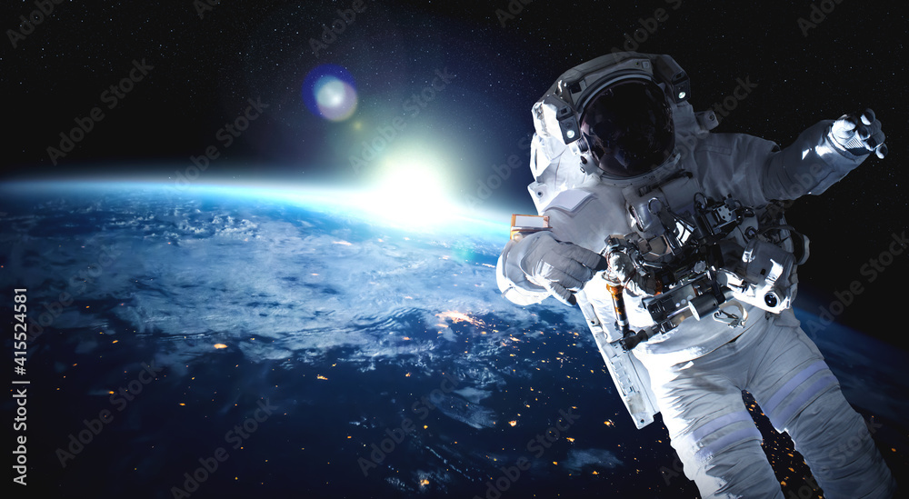 Wall mural astronaut spaceman do spacewalk while working for space station in outer space . astronaut wear full