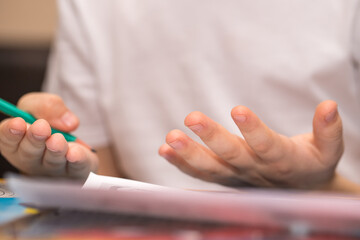 a six-year-old boy solves a math example with his fingers. close-up