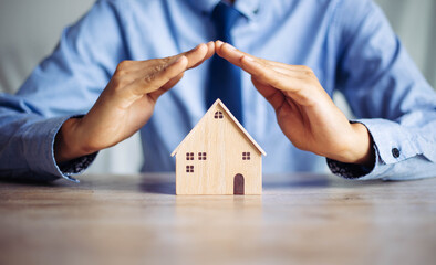 Insurance house, and family health live concept. The insurance agent presents  the ้hands...