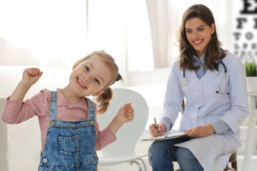 Doctor working with little patient in hospital.