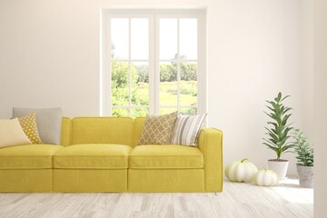 White living room with yellow sofa and summer landscape in window. Scandinavian interior design. 3D illustration