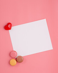 card with heart and macaroons on pink background 