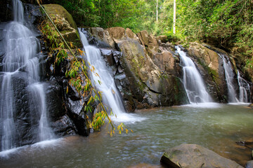 waterfall in the forest or motion of water at brook of water fall. with tree leaf and stone rock....