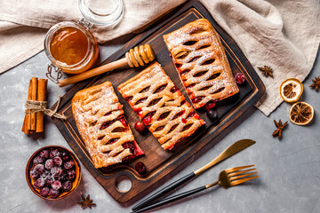 Three pieces sweet pie with berries and powdered sugar, top view