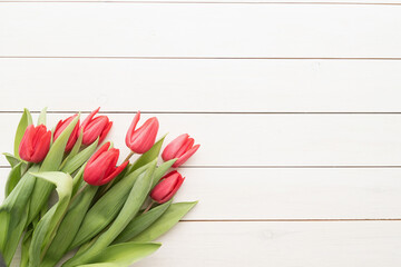 Bouquet of spring tulips over white wooden background