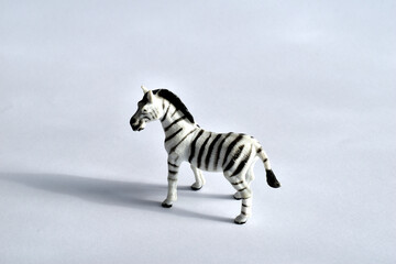 Fototapeta premium Children's toy. Zebra on white. Made of plastic. Side view.
