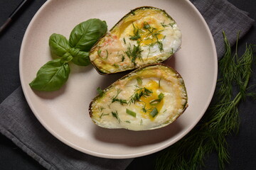 Baked avocado and eggs boats with parmesan, basil