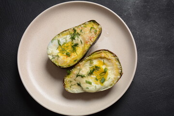 Baked avocado and eggs boats with parmesan, basil