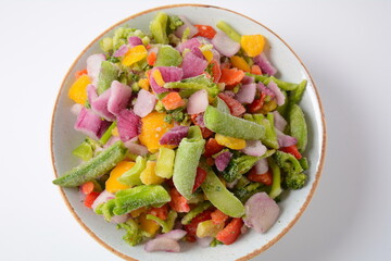 Frozen vegetable mixture of carrots, broccoli ,peppers, red onion and peas. Healthy food