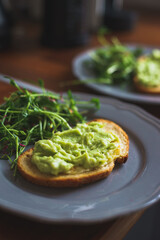 Full healthy morning breakfast: toast with guacamole, avocado, poached egg and flaxseed.