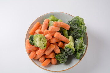 Small frozen pieces of  broccoli and carrots.  Healthy food. Frozen vegetables