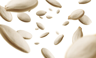 Pumpkin seeds levitate on a white background