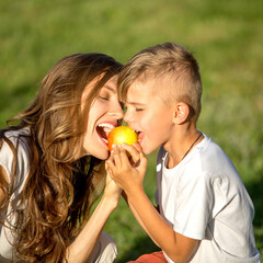 Happy mother and her son at picnic in park