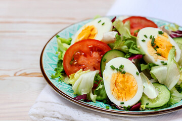 Healthy salad with lettuce, tomatoes and eggs.