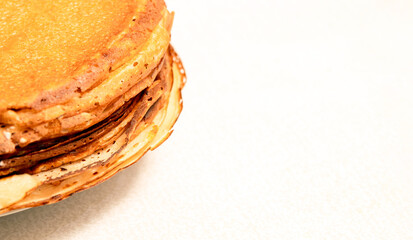 A stack of pancakes on a white background. Banner for advertising Maslenitsa. Selective focus.