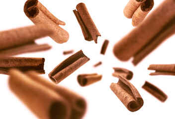 Cinnamon sticks levitate on a white background