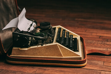 retro typewriter on wooden background and paper decoration texture