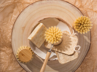 Zero waste natural dish washing kitchen home eco cleaning products - wooden brushes, loofah sponge, bio soap bar on neutral beige background