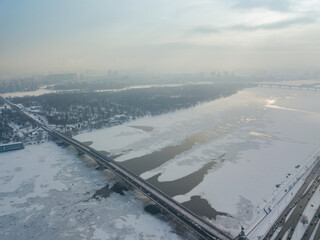 Kiev metro bridge across the Dnieper river. Aerial drone view. Winter sunny morning.