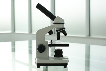 Medical microscope on a glass table in a bright room