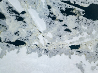 Ice crack on the river. Aerial drone view. Winter frosty morning.