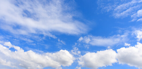 White clouds on the blue sky for background.