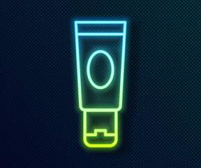 Glowing neon line Cream or lotion cosmetic tube icon isolated on black background. Body care products for woman. Vector.