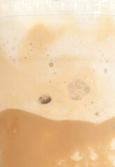Detail of milk mixing in ice coffee drink, Fresh beverages background.