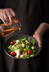 Chef keeps freshly preperd salad and refined with olive oil.