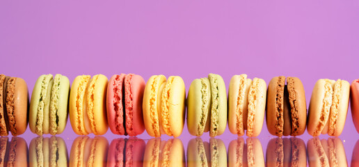 Colorful french macarons on background