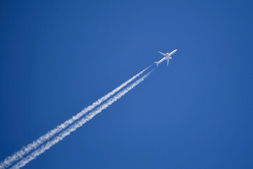 Jet plane on blue sky with vapor trail. Travel by airplane concept. 