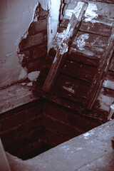 Strange scary dark wooden open mystical mysterious old door to abandoned basement, horror background with grunge texture with black shadows and red bloody glow